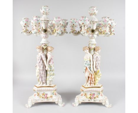 A LARGE PAIR OF DRESDEN STYLE SEVEN LIGHT CANDELABRA with sjx scrolling branches, the support with three classical young ladi