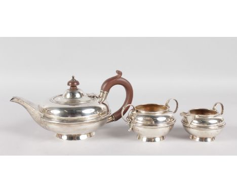 A CIRCULAR THREE PIECE TEA SET, comprising teapot with wooden handle and finial, sugar basin and milk jug. Chester 1919.  Gro