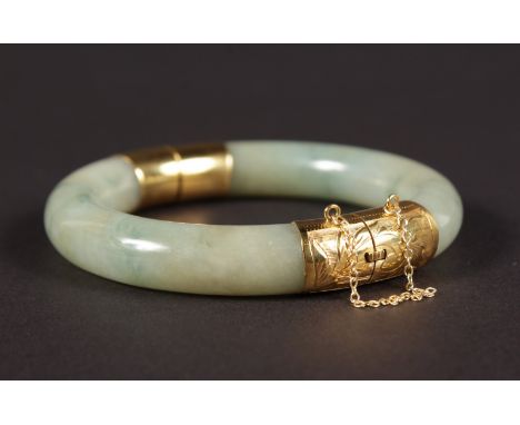 A GOOD JADE GOLD MOUNTED BANGLE.
