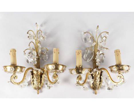 A PAIR OF 1920'S FRENCH GILT METAL TWO LIGHT WALL LIGHTS, hung and inset with crystals. 15ins long.