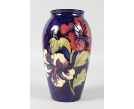 A MOORCROFT HIBISCUS PATTERNED VASE. Impressed MOORCROFT with printed label.  7.5ins high.