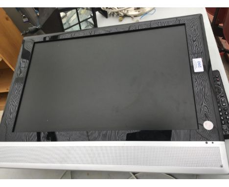 A TELEVISION ON A WALL BRACKET WITH REMOTE CONTROL IN WORKING ORDER 