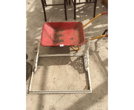 A VINTAGE CAST SHELF FRAME WITH BRACKETS AND A CHILDS WHEELBARROW 