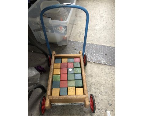A CHILDREN'S VINTAGE WOODEN TROLLEY WITH BUILDING BLOCKS 