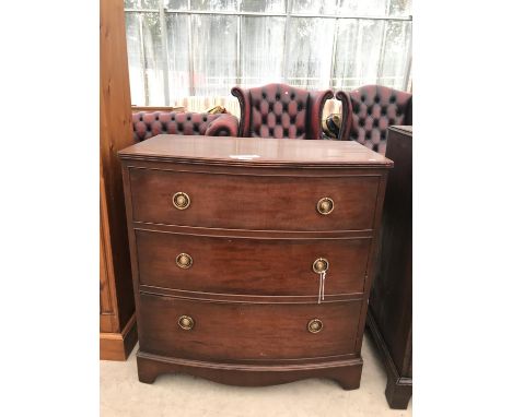 A BOW FRONT MAHOGANY CHEST OF THREE DRAWERS ON BRACKET FEET 