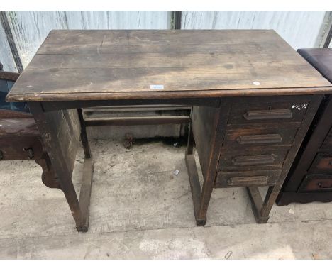 A VINTAGE OAK DESK WITH FOUR DRAWERS 