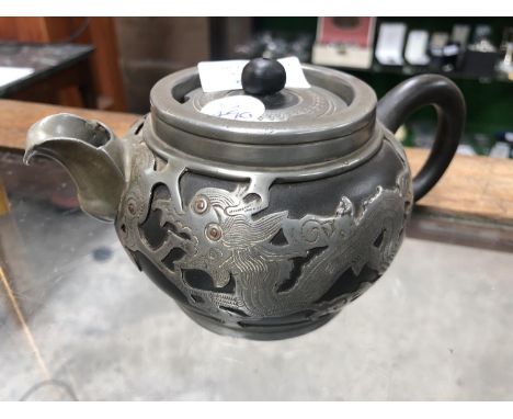 A CHINESE BLACK YIXING STYLE TEAPOT WITH PEWTER OVERLAY, MARKED TO BASE 