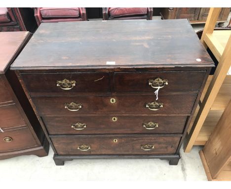 AN OAK CHEST OF TWO SHORT AND THREE LONG DRAWERS WITH ORNATE BRASS HANDLES ON BRACKET FEET 