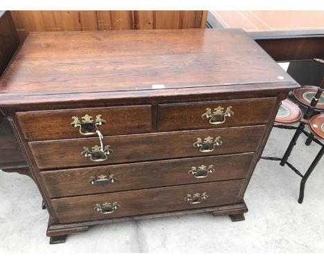 AN OAK CHEST OF TWO SHORT AND THREE LONG DRAWERS WITH ORNATE BRASS HANDLES ON BRACKET FEET 