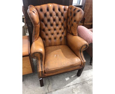A TAN LEATHER BUTTON BACK CHESTERFIELD WING BACK ARMCHAIR 