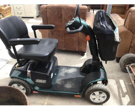 A COLT MOBILITY SCOOTER IN CLEAN CONDITION AND WORKING ORDER (KEY AND CHARGER IN SAFE) AND A SLEEVED MOBILITY PONCHO 