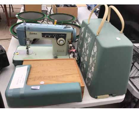 A VINTAGE JONES SEWING MACHINE WITH CASE AND SPARE PARTS 