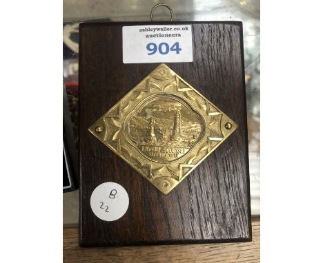 A VINTAGE GERMAN 'ZEPELLIN' METAL PLAQUE ON OAK DISPLAY 