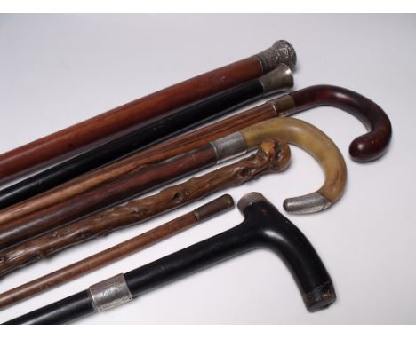 A COLLECTION OF SIX VINTAGE WALKING CANES / STICKS, various periods and styles, to include silver banded examples, together w