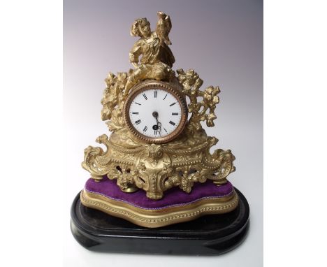 A FRENCH SPELTER MANTEL CLOCK, with figural surmount of 'Boy with Fish', the enamel face with Roman numerals, barrel movement