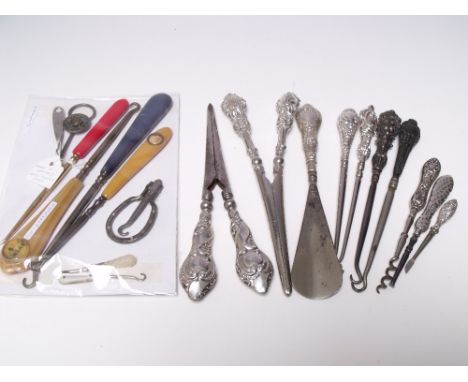 A COLLECTION OF SILVER HANDLED BUTTON HOOKS AND SHOE HORNS ETC, together with a small selection of similar vanity items (Appr