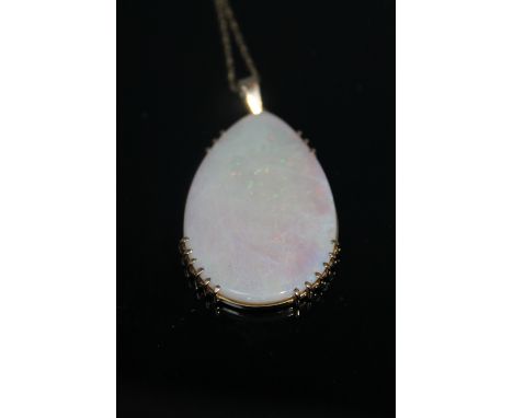 A 9CT TEARDROP OPAL PENDANT, the opal measuring 34 mm x 23 mm Buyers - for shipping pricing on this lot, visit www.cuttleston