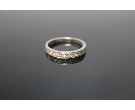 A PLATINUM HALF ETERNITY DIAMOND RING, set with nine graduated diamonds totaling approx 0.44 cts, ring size R Buyers - for sh