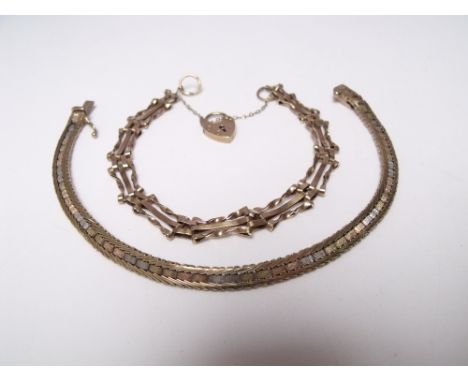 A HALLMARKED 9CT GOLD ORNATE THREE-BAR GATE BRACELET, with heart shaped clasp and safety chain, together with another gold br