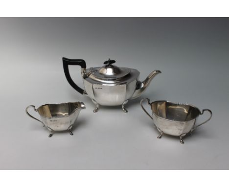 A HALLMARKED SILVER THREE PIECE TEA SERVICE - SHEFFIELD 1931, being of plain panelled form and each piece sat upon four pad f