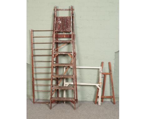 A large wooden step ladder with two wooden clothes horse and an easel  