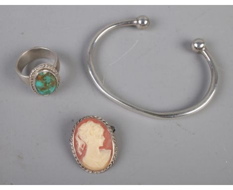 A silver bangle with turquoise ring and cameo brooch, all silver.  