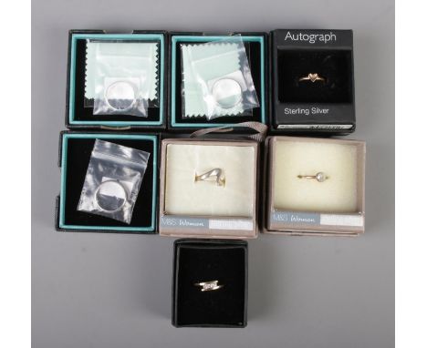 Seven boxed silver rings. Includes bands, paste set etc.  