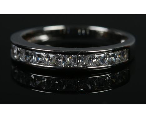 A silver half eternity ring channel set with clear paste stones. Size R½, 2.4g.