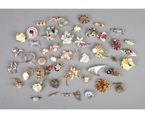 A collection of assorted costume jewellery brooches to include Monet, floral, stag, cameo and petite point examples.  