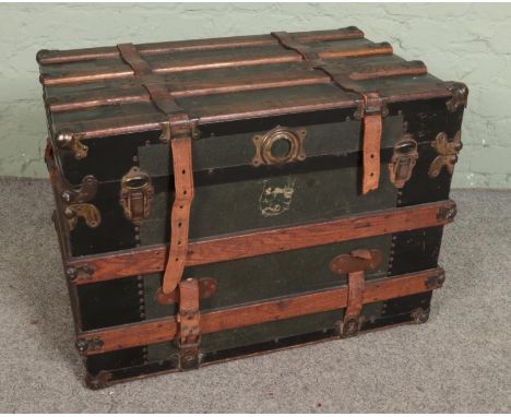 A large wood bound steamer travel trunk  
