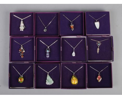 Twelve silver necklace chains with pendants. To include amber coloured lantern, resin, mother of pearl, Buddha and clown exam