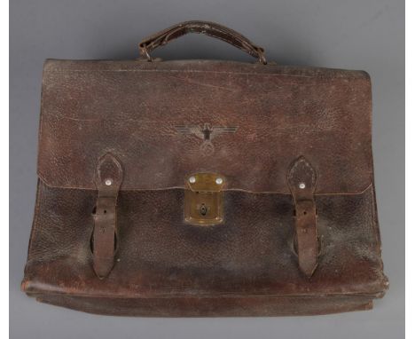 A WW2 era leather satchel/briefcase having embossed eagle swastika stamp to front.  