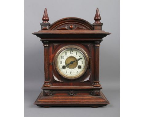 An oak cased mantle clock, with Arabic numeral dial, featuring Junghans movement. Chiming on a coiled gong. Key and pendulum 