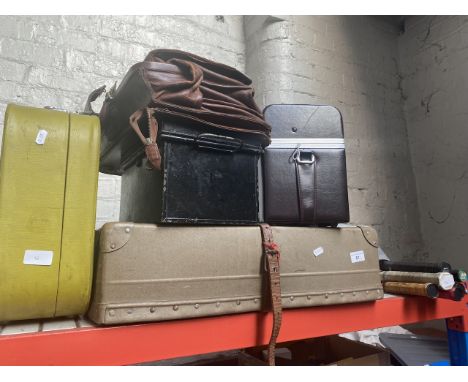 A vintage laundry case, first aid metal case, a camera case, a suitcase, a briefcase and a bundle of tennis and badminton rac