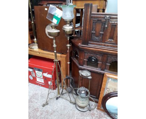 Two floor standing paraffin lamps and a hanging lamp. 