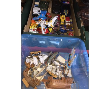 Two boxes of various die cast and plastic model vehicles and model ships. 