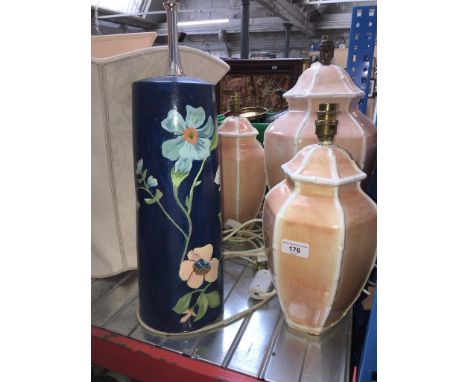 3 matching pottery lamps, a blue painted with flowers vase type lamp and 4 shades in various sizes. 