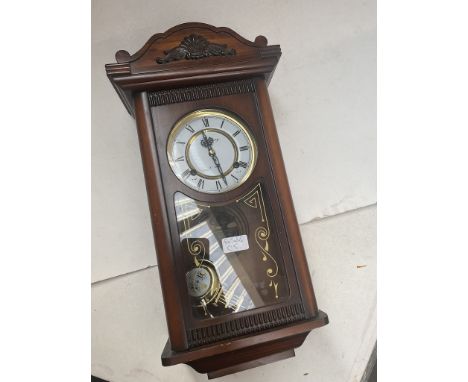 A Canterbury 31 day wall clock with key. 