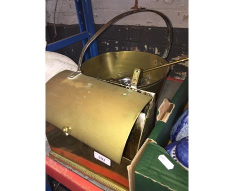 A large brass jam pan with contents to include poker, cutlery, enamelled clock face and a brass desk tidy. 
