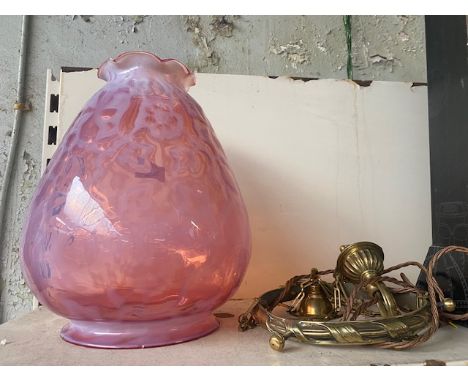 A brass light fitting with cranberry glass shade.Condition Report: There is a chip on the base of the item.