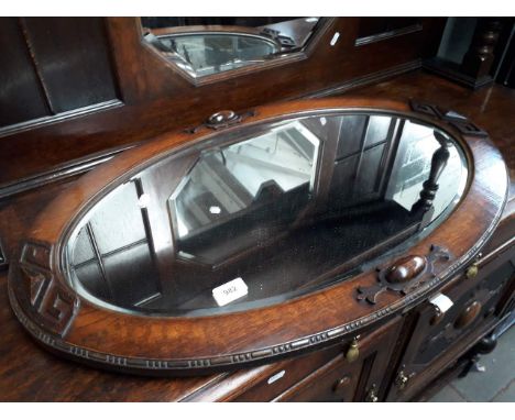 A carved oak framed mirror and a modern mirror 