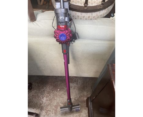 A Dyson stick vacuum with charger - in working order. 