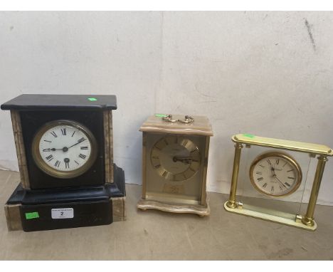 A marble slate clock, a brass and alabaster clock and another. 