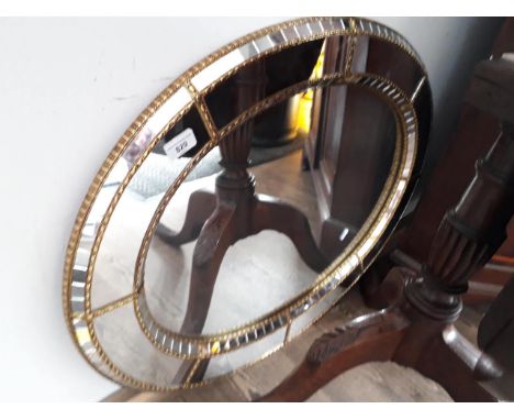An oval mirror 184cm x 67cm. 