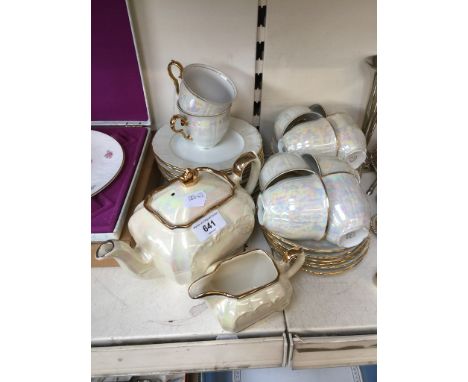 A tea set; 10 cups, 10 saucers, 10 side plates and a teapot 