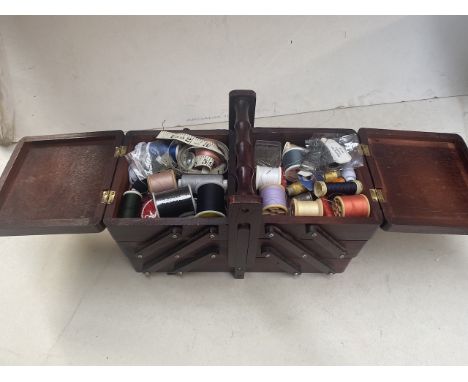 A cantilever sewing box with tapestry top, with contents 