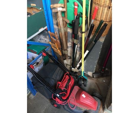 A Sovereign electric lawn mower, lawn edger, a lopper, spade, fork, couple of saws, Hozelock hose reel. 