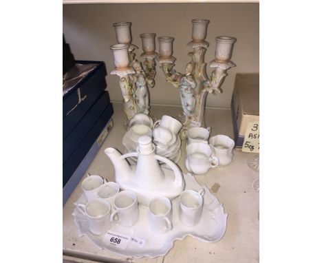 Continental porcelain comprising a German drinking set, Limoges cups and saucers and a pair of candelabras. 