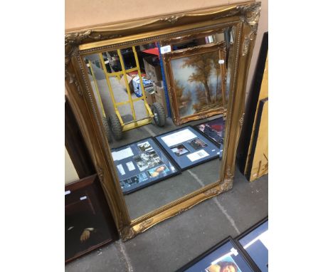 A large mirror in ornate gilded frame approx 106 x 75 cm 