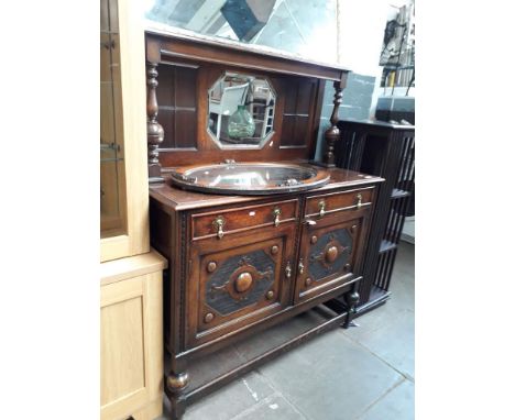 An oak sideboard with mirror back shelf 